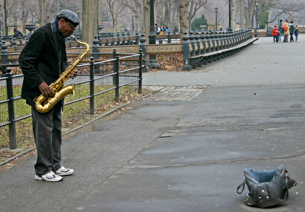 man playing saxophone in park