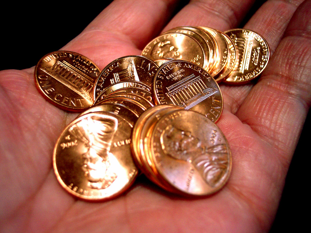 hand holding pennies
