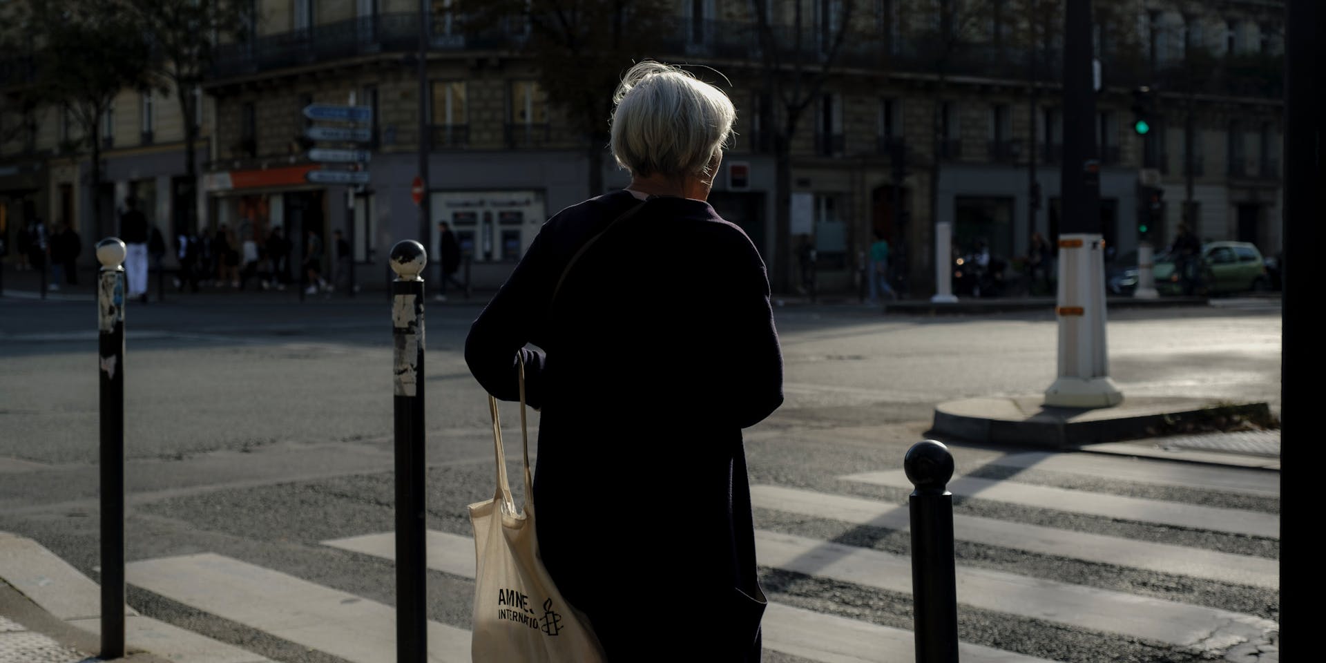 Woman waiting to cross at crosswalk